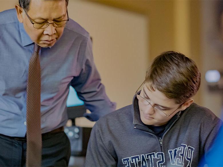 Dr. Min working with a student